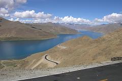 
The road from Lhasa to Gyantse (260km) took us over two mountain passes. From the Kamba La (4794m), we had a fantastic view of the beautiful Yamdrok Tso (Turquoise lake) with Nojin Kangtsang (7191m) behind, hidden in the clouds. In the foreground is the new paved road just opened in June 2005, in preparation for the 40th anniversary of the creation of the Tibet Autonomous Region.
